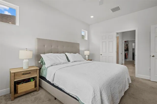 a bedroom with a bed and a dresser