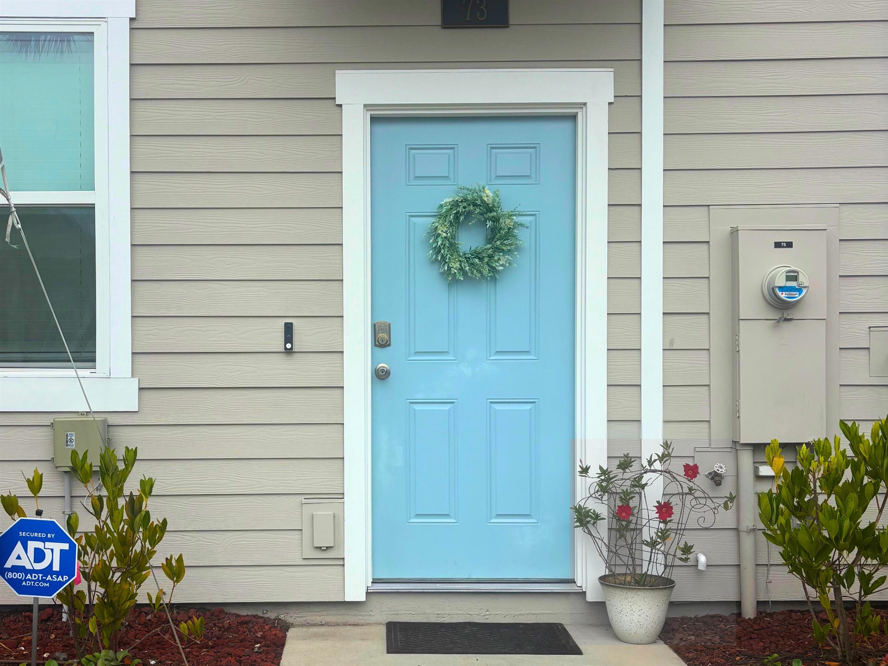 73 Elmhurst Lane St. Augustine, FL 32084 - Photo 2 of 21 a potted plant sitting in front of a door