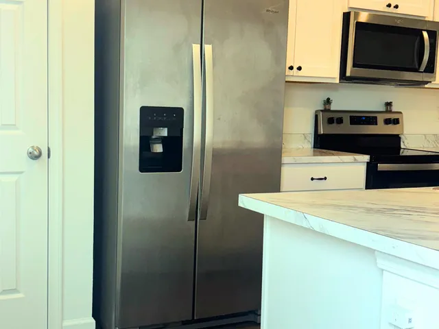 a view of a kitchen with electric appliances