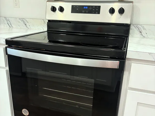 a kitchen with a appliances wooden cabinets and a counter top space