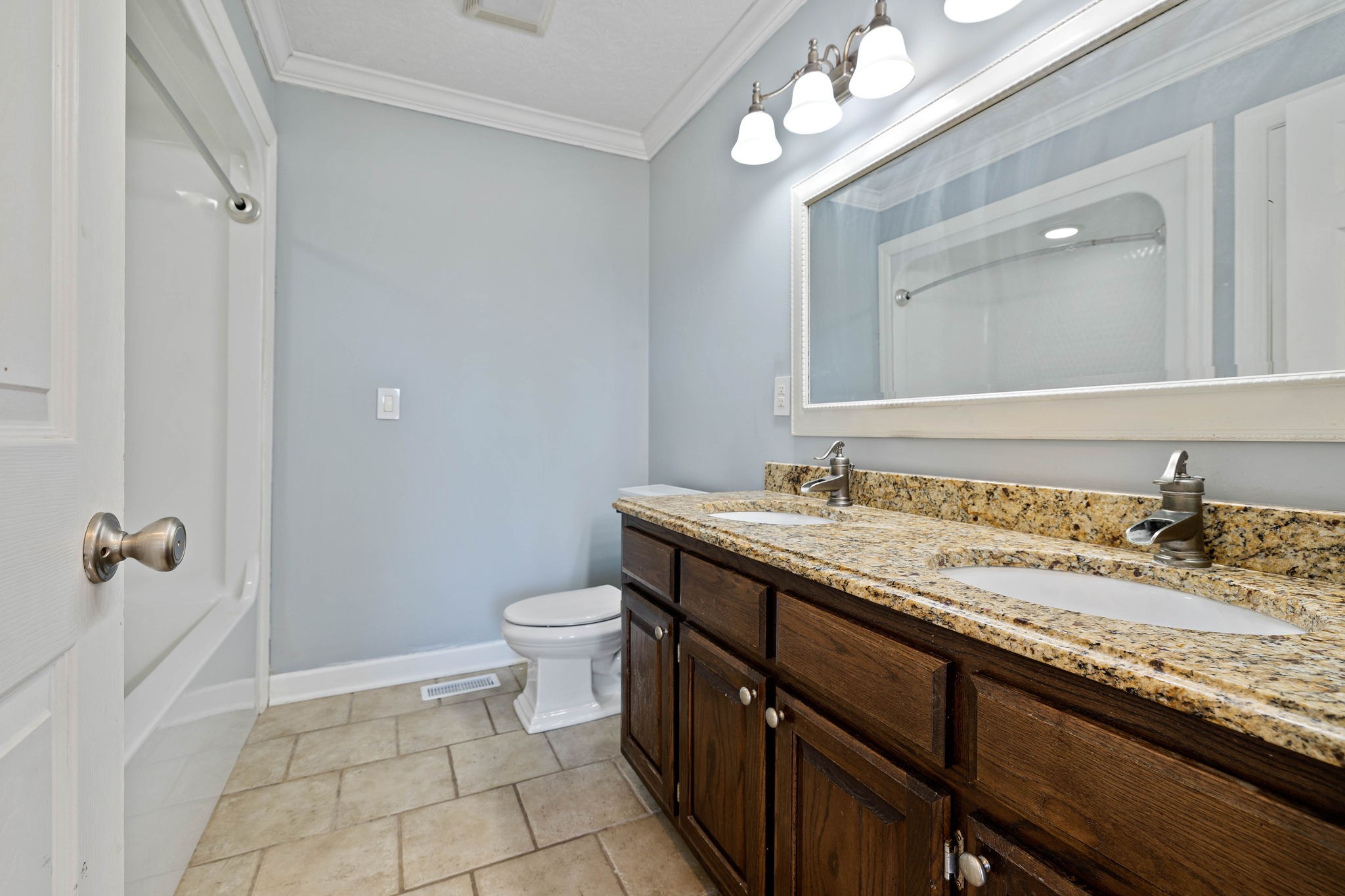 533 Rome Road Riddleton, TN 37151 - Photo 23 of 43 a bathroom with a granite countertop sink a toilet and a mirror