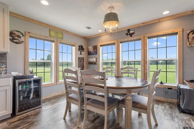 a view of a dining room with furniture large windows and wooden floor