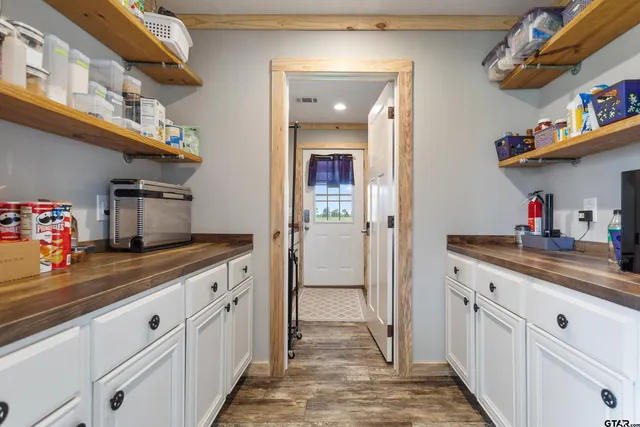 a kitchen with cabinets and window