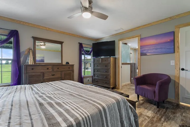 a bedroom with a bed dresser and a chair