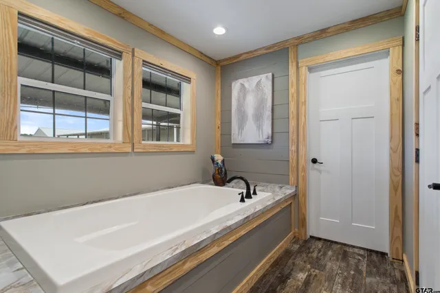 a spacious bathroom with a bathtub and a window