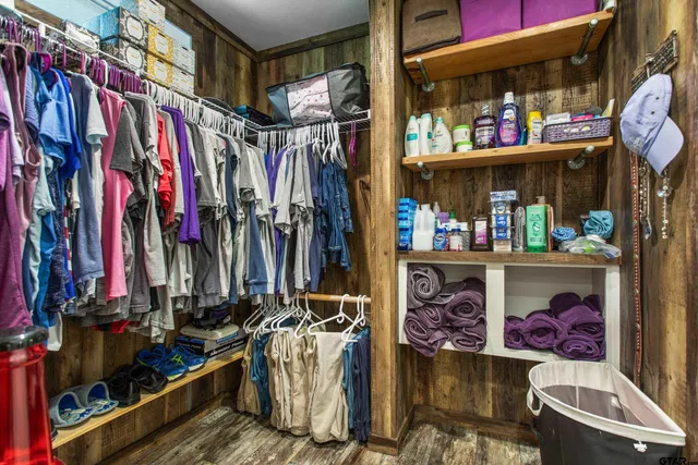 a bedroom with a bed window and a flat screen tv