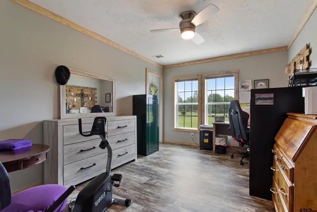 a living room with furniture kitchen view and a flat screen tv
