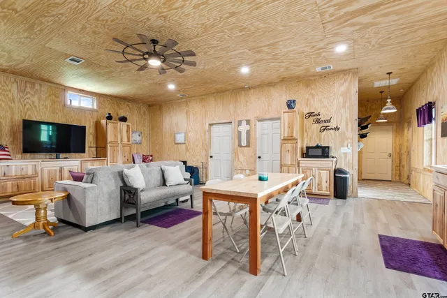 a kitchen that has a table and chairs in it