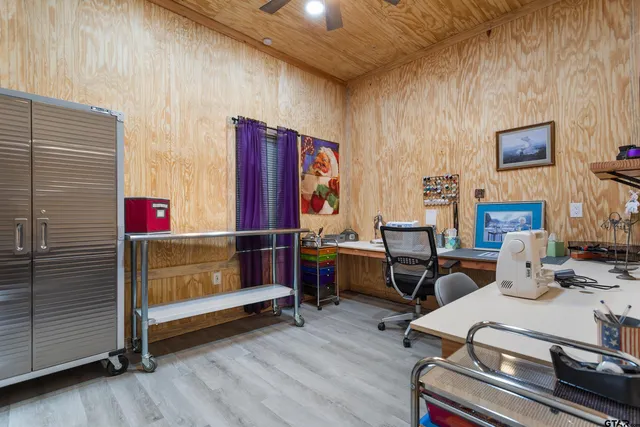 a view of a workspace with furniture and a window