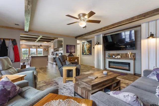 a living room with furniture fireplace and flat screen tv