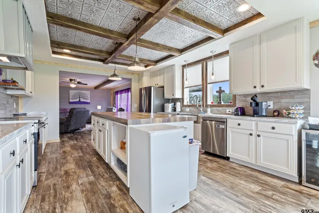 a kitchen with cabinets a sink and appliances
