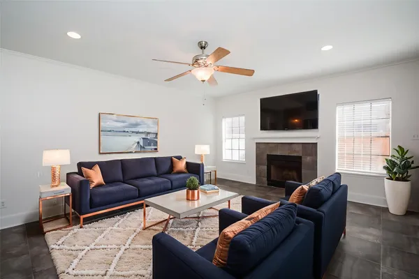 a living room with furniture a fireplace and a flat screen tv