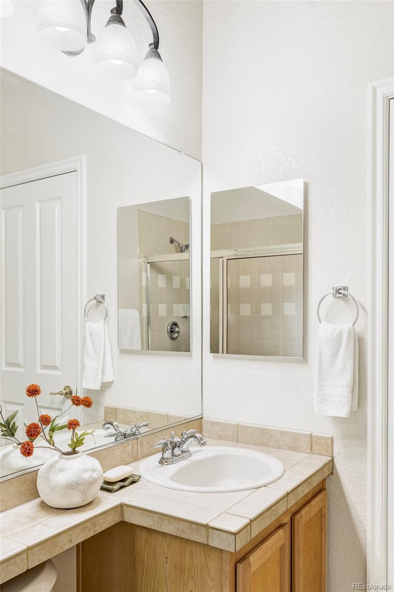 10715 Riverbrook Circle Highlands Ranch, CO 80126 - Photo 17 of 30 a bathroom with a sink and a mirror