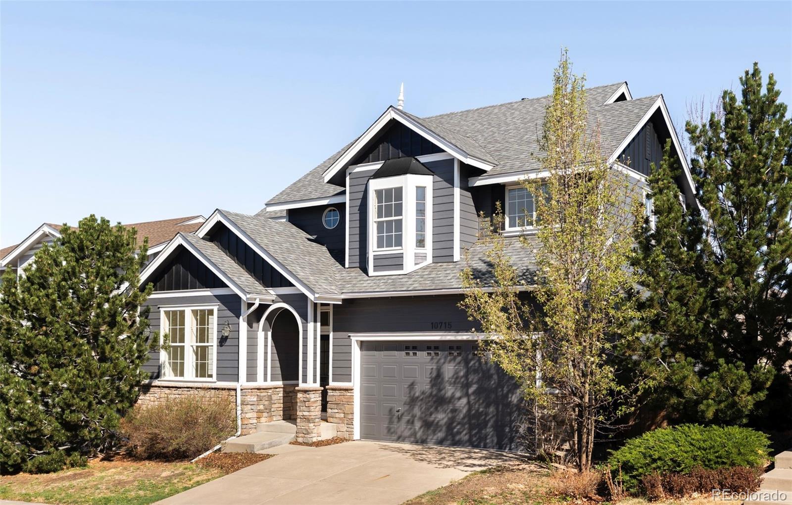 10715 Riverbrook Circle Highlands Ranch, CO 80126 - Photo 2 of 30 a front view of a house with garden