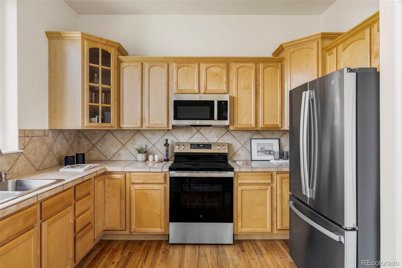 10715 Riverbrook Circle Highlands Ranch, CO 80126 - Photo 7 of 30 a kitchen with a refrigerator stove and sink