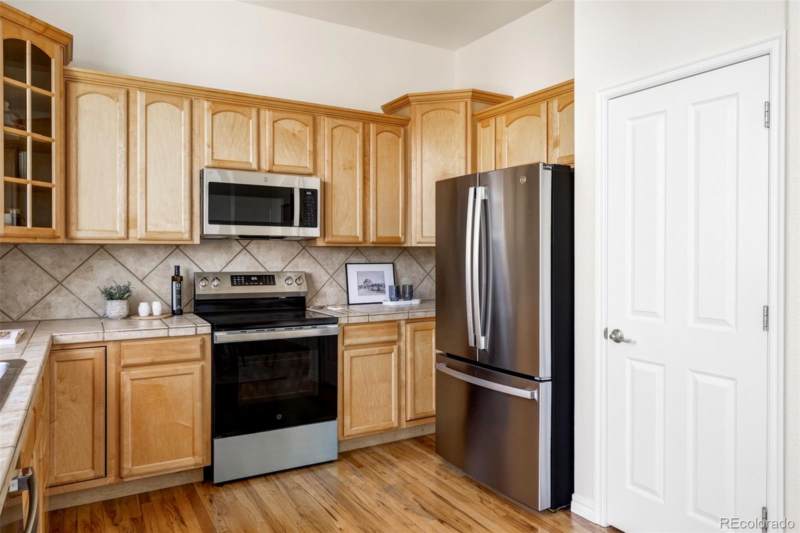 10715 Riverbrook Circle Highlands Ranch, CO 80126 - Photo 9 of 30 a kitchen with a refrigerator stove and microwave