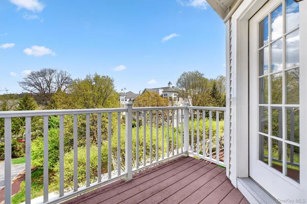 a view of a balcony with wooden floor