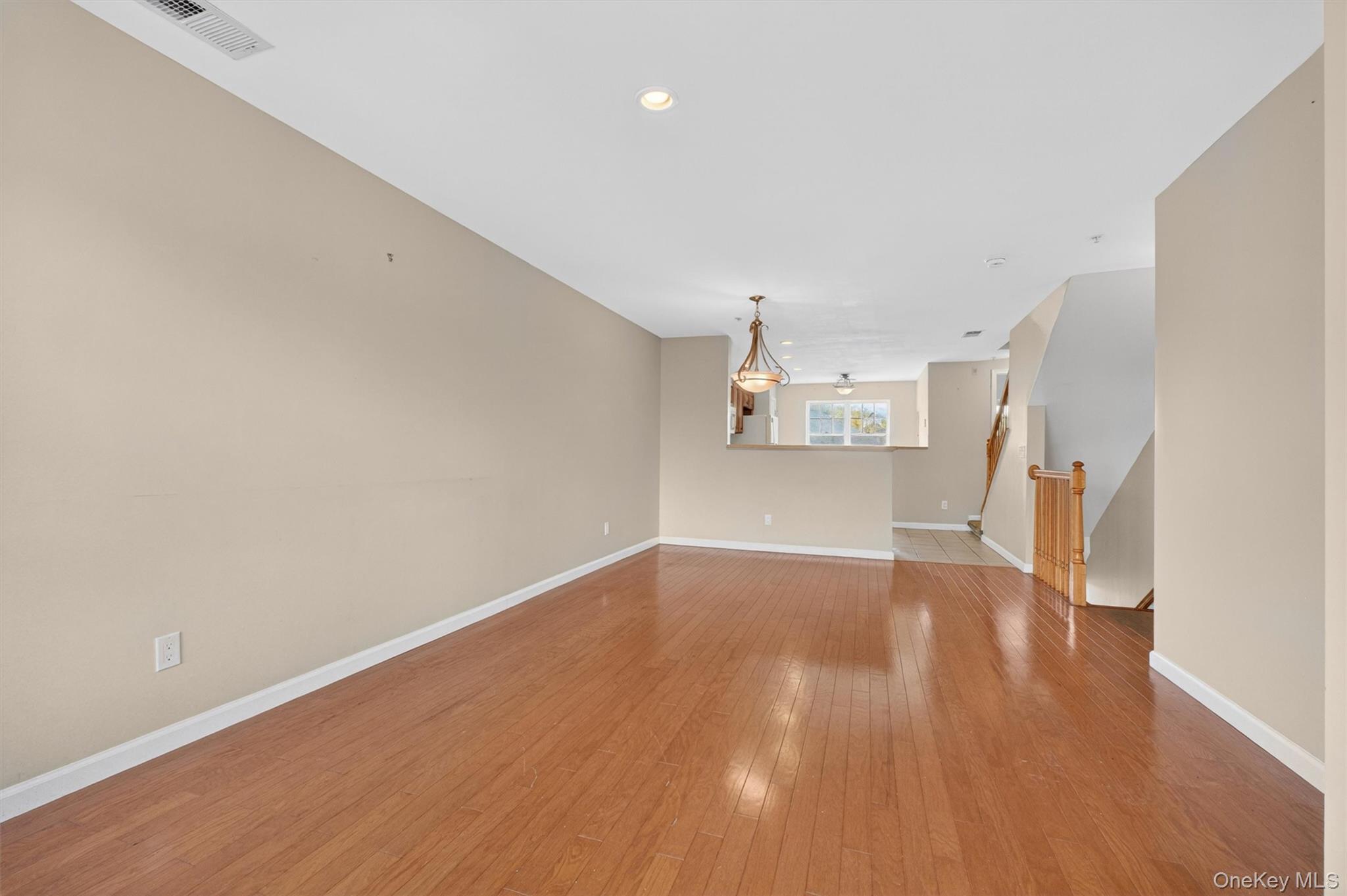 422 Highridge Court, Unit 422 Peekskill, NY 10566 - Photo 45 of 45 The expansive floor plan stretches from front to back, allowing for easy movement and connection between spaces, while large windows fill the entire level with abundant natural light—creating an airy, inviting atmosphere that is perfectly suited for gatherings both large and small.