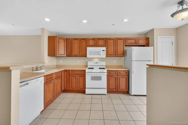 a kitchen with a stove sink and refrigerator