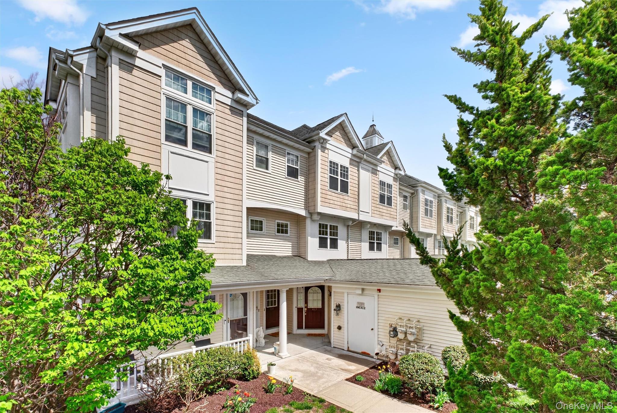 422 Highridge Court, Unit 422 Peekskill, NY 10566 - Photo 2 of 45 A welcoming, tree-lined sidewalk approach leads to your private entry, offering a charming and inviting introduction to this beautifully positioned townhome, just moments from the riverfront and all the lifestyle amenities Riverbend has to offer.