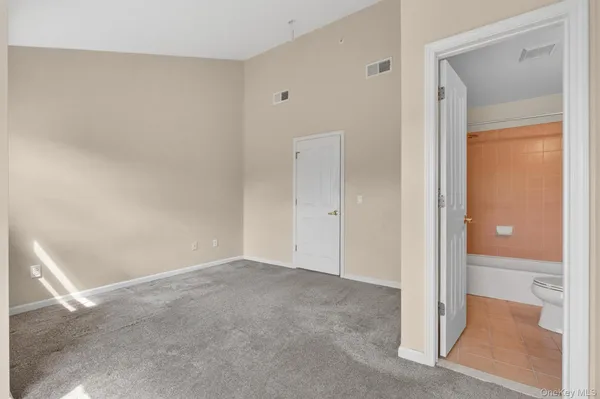 a view of an empty room and closet area