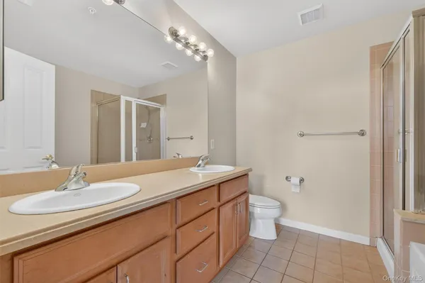 a bathroom with a sink double vanity and a mirror