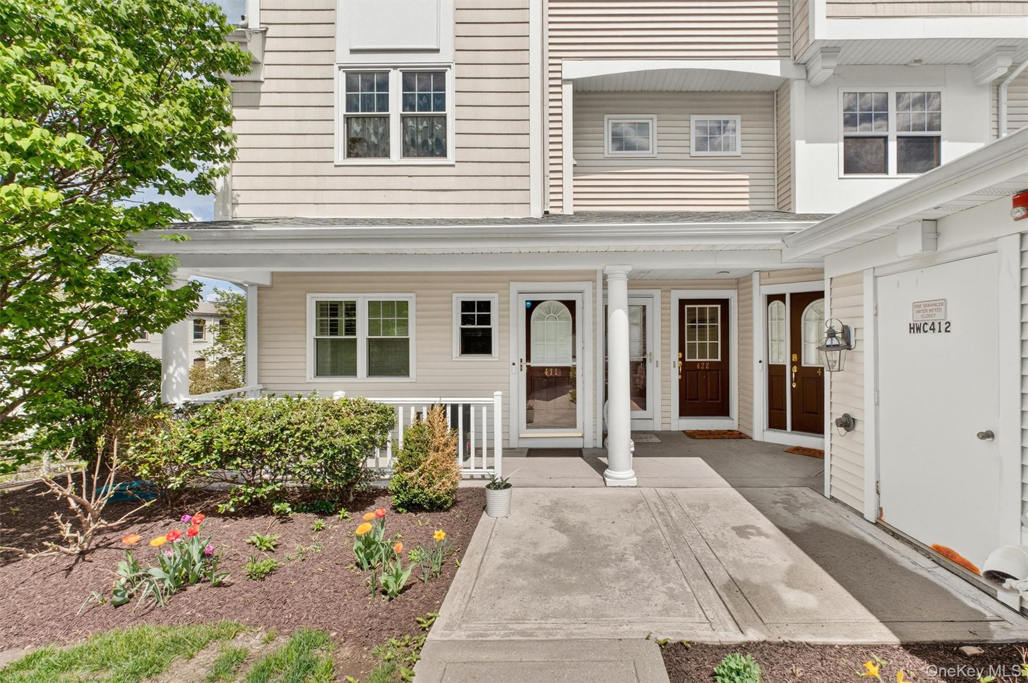 422 Highridge Court, Unit 422 Peekskill, NY 10566 - Photo 3 of 45 Enjoy a picturesque sidewalk approach that guides you to your private entrance—perfectly blending neighborhood charm with everyday convenience.
