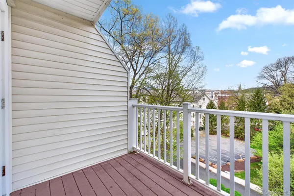 a view of a balcony with wooden floor