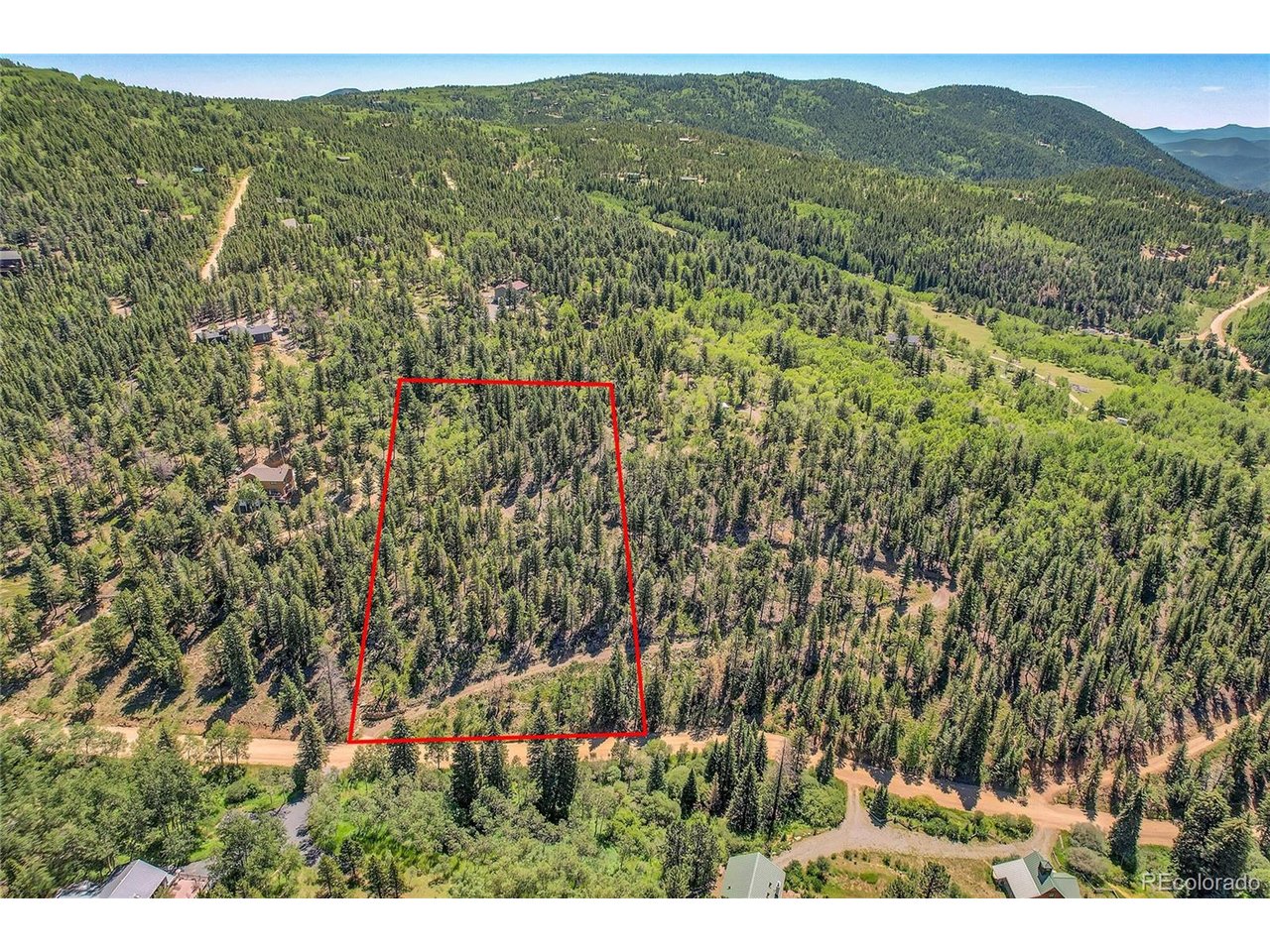 9 Hughesville Road Black Hawk, CO 80422 - Photo 15 of 17 a view of a lush green field with a lake
