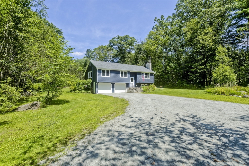 117 Beetle Road Tolland, MA 01034 - Photo 3 of 33 a view of a house with garden and a patio
