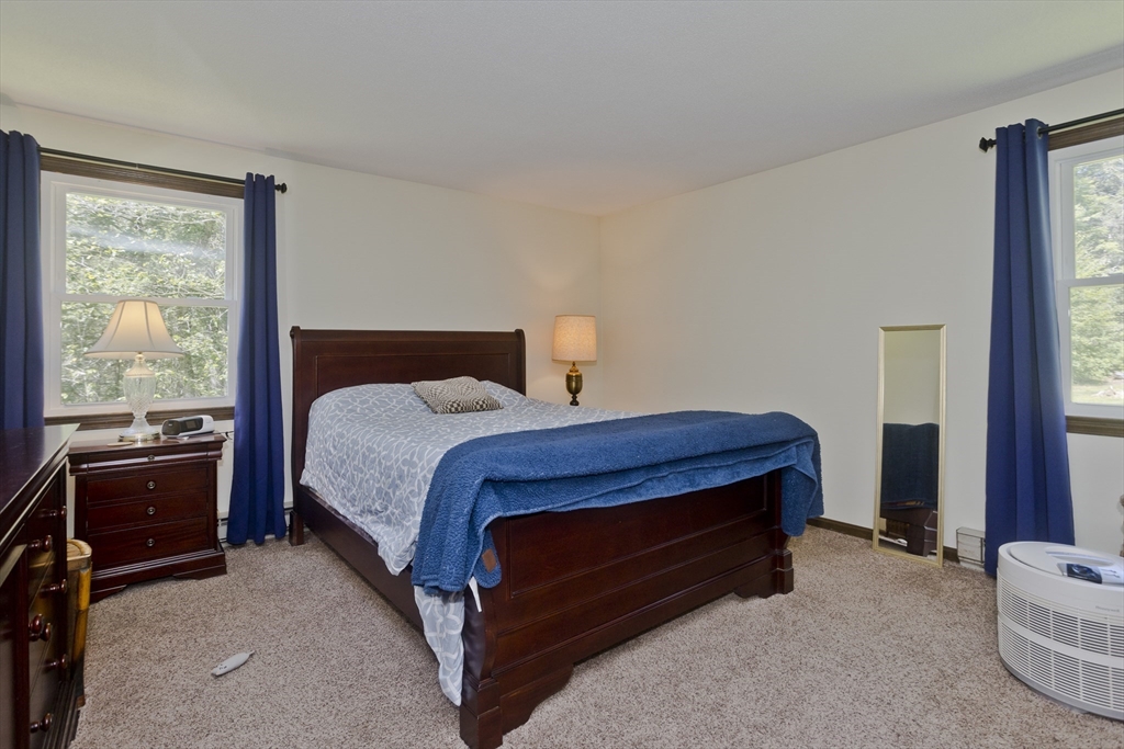 117 Beetle Road Tolland, MA 01034 - Photo 8 of 33 a bed sitting in a bedroom next to a window