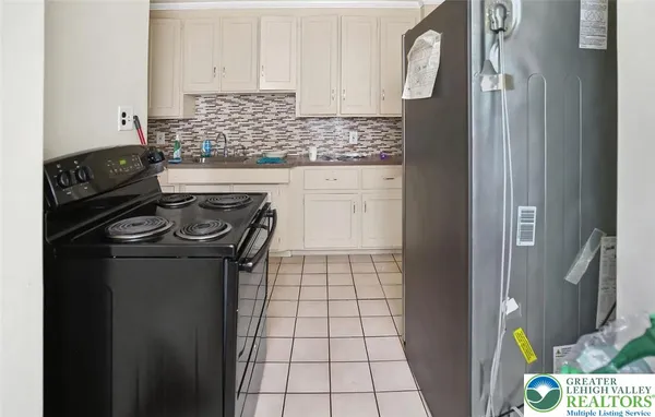 a kitchen with a stove and a refrigerator