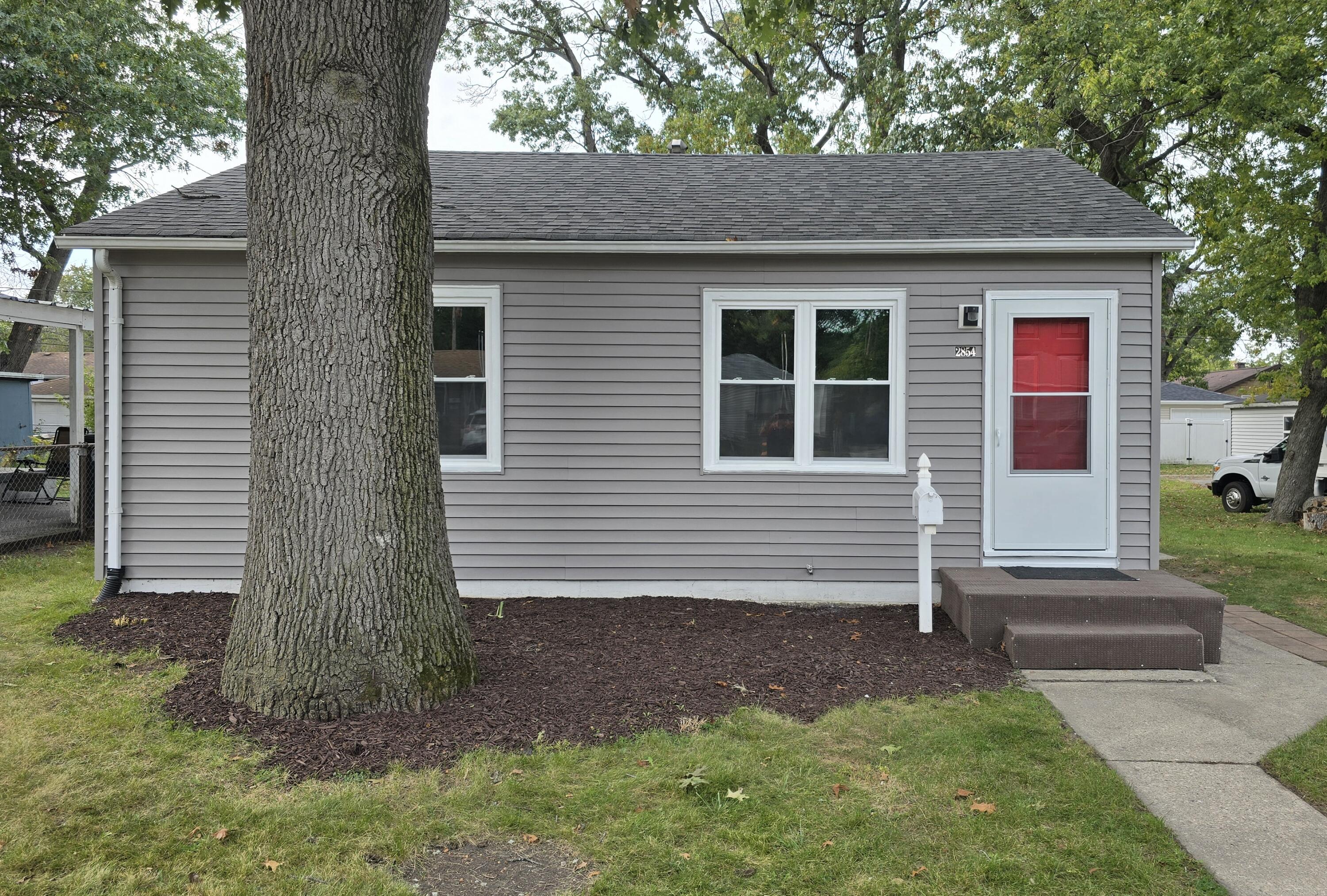 2854 Hancock Street Gary, IN 46405 - Photo 12 of 13 a front view of a house with garden