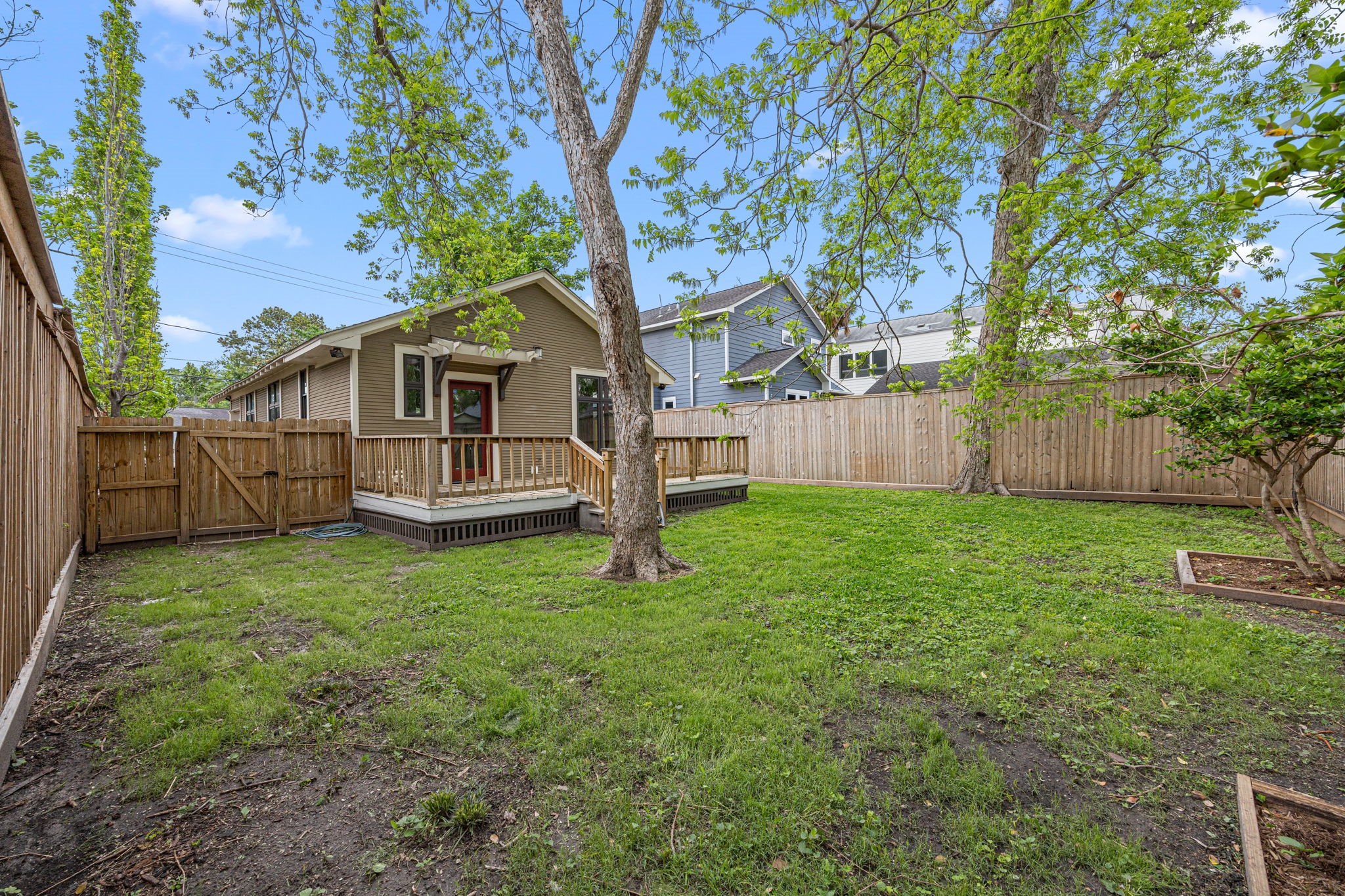 1115 Adele Street Houston, TX 77009 - Photo 16 of 19 Elevated view of backyard highlighting deck access and fully fenced perimeter.