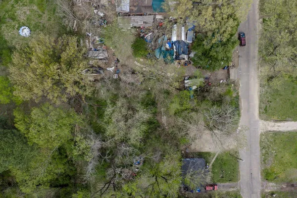an aerial view of residential house with outdoor space and trees all around