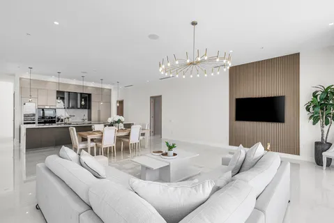 a living room with furniture a dining table and a fireplace