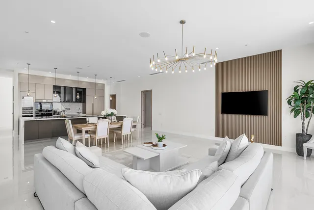 a living room with furniture a dining table and a fireplace