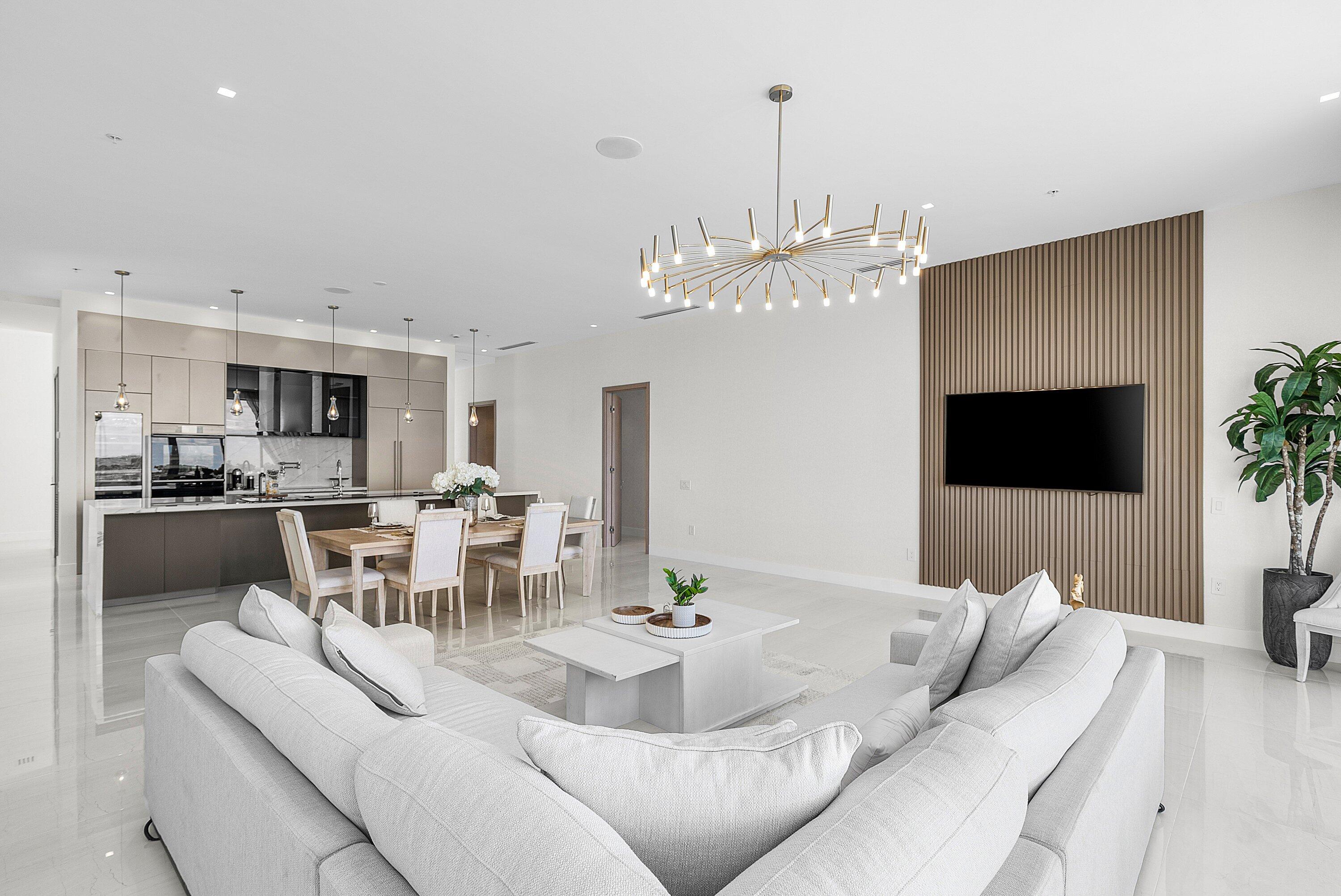 246 Northeast 6th Avenue, Unit PH Delray Beach, FL 33483 - Photo 13 of 36 a living room with furniture a dining table and a fireplace