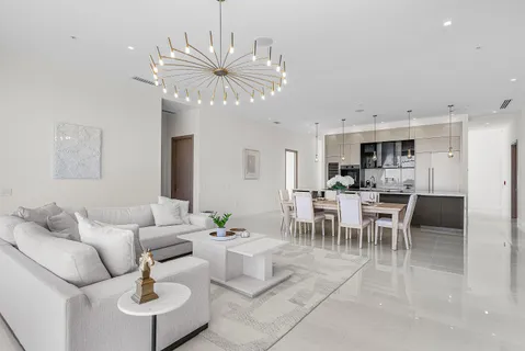 a living room with furniture dining table and a chandelier