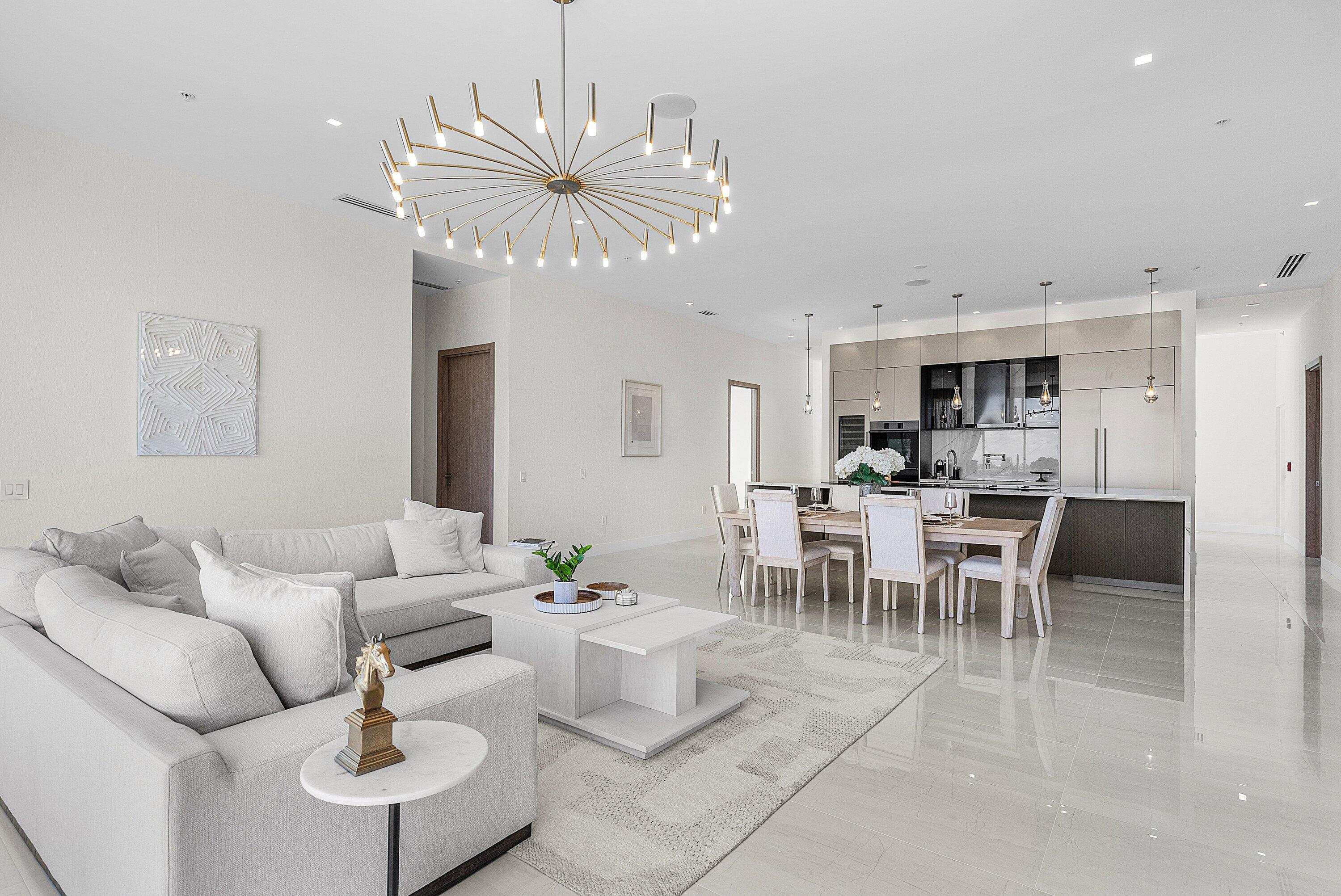 246 Northeast 6th Avenue, Unit PH Delray Beach, FL 33483 - Photo 14 of 36 a living room with furniture dining table and a chandelier