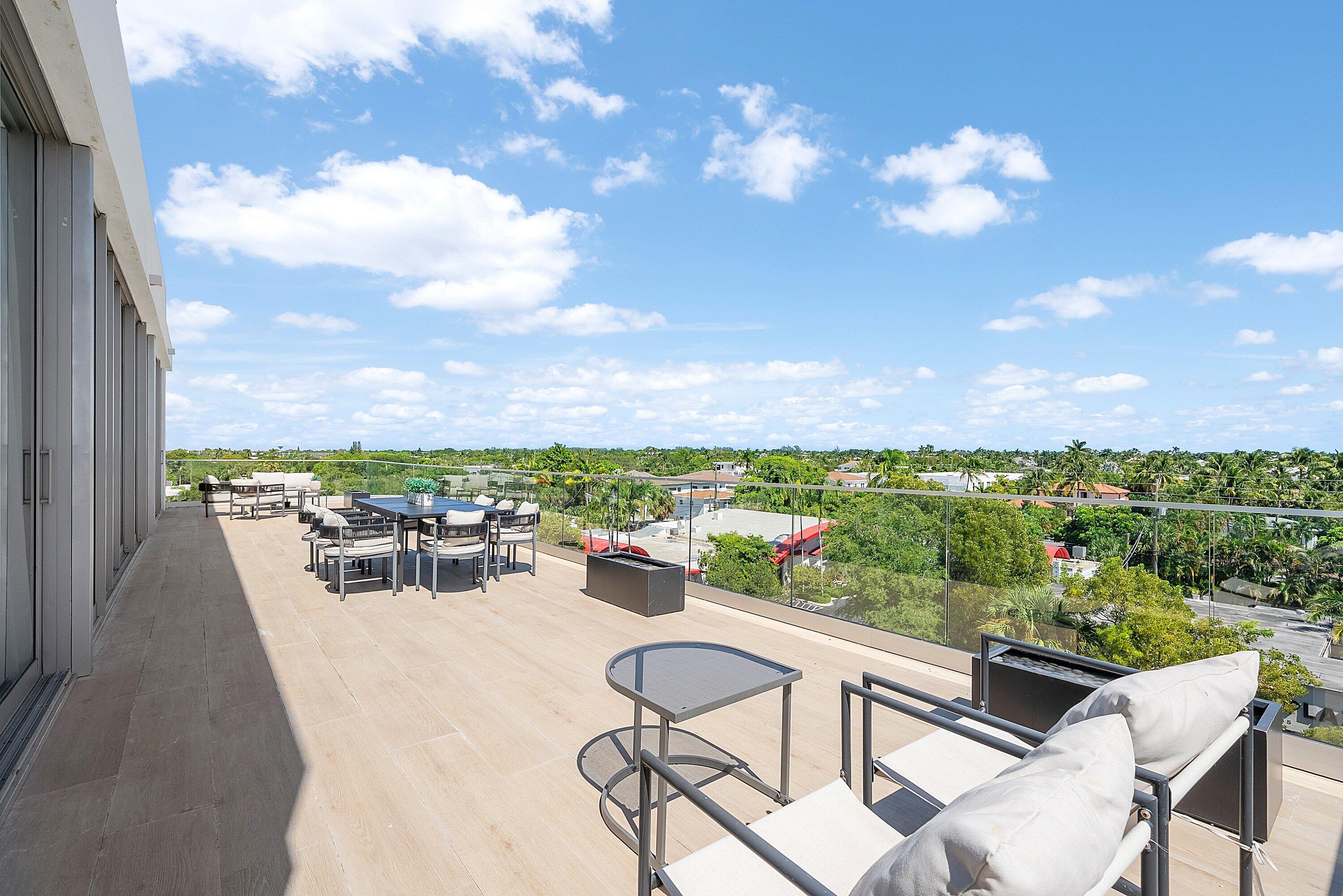 246 Northeast 6th Avenue, Unit PH Delray Beach, FL 33483 - Photo 17 of 36 a view of a chairs and table in patio