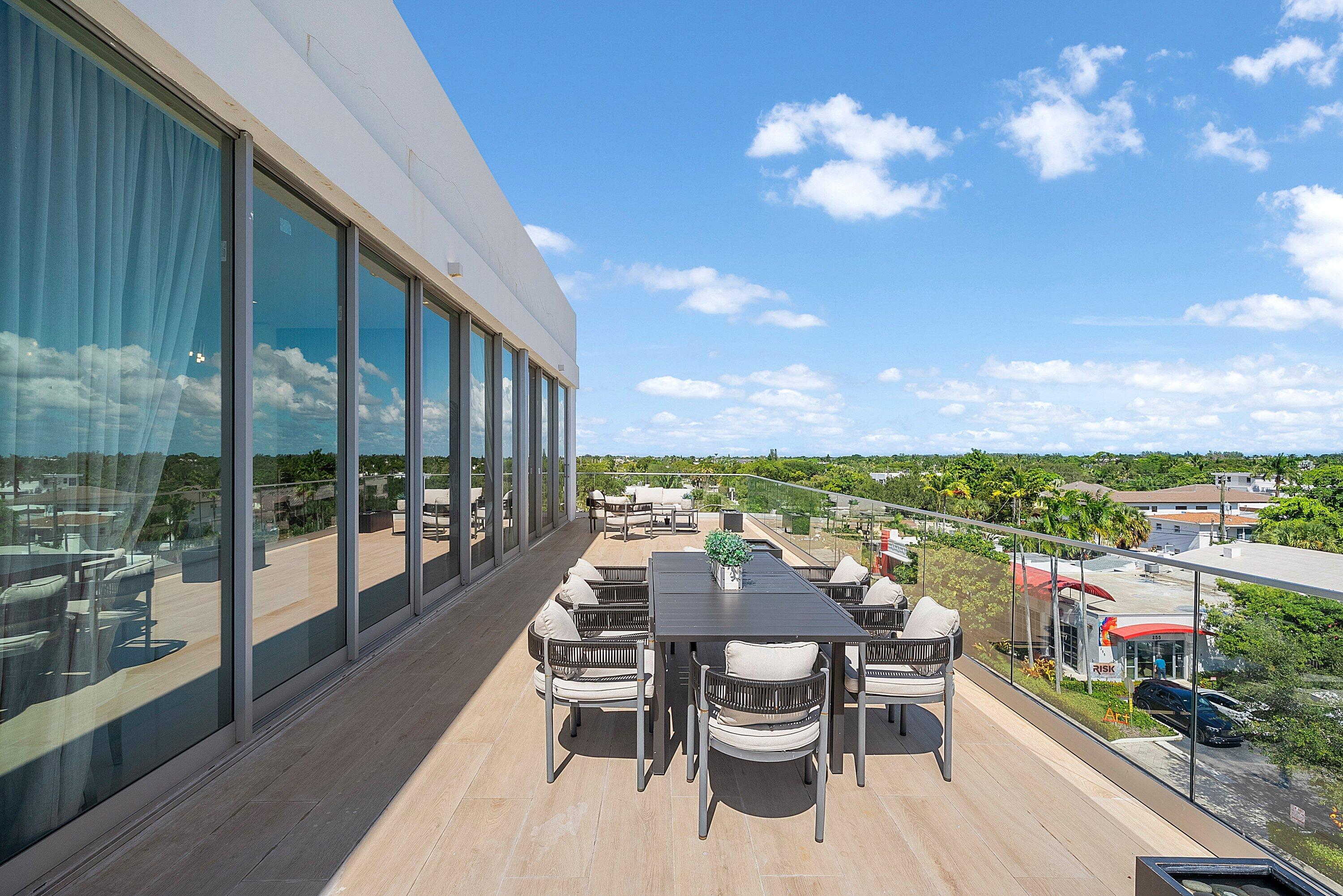 246 Northeast 6th Avenue, Unit PH Delray Beach, FL 33483 - Photo 18 of 36 a view of a balcony with chairs and a table