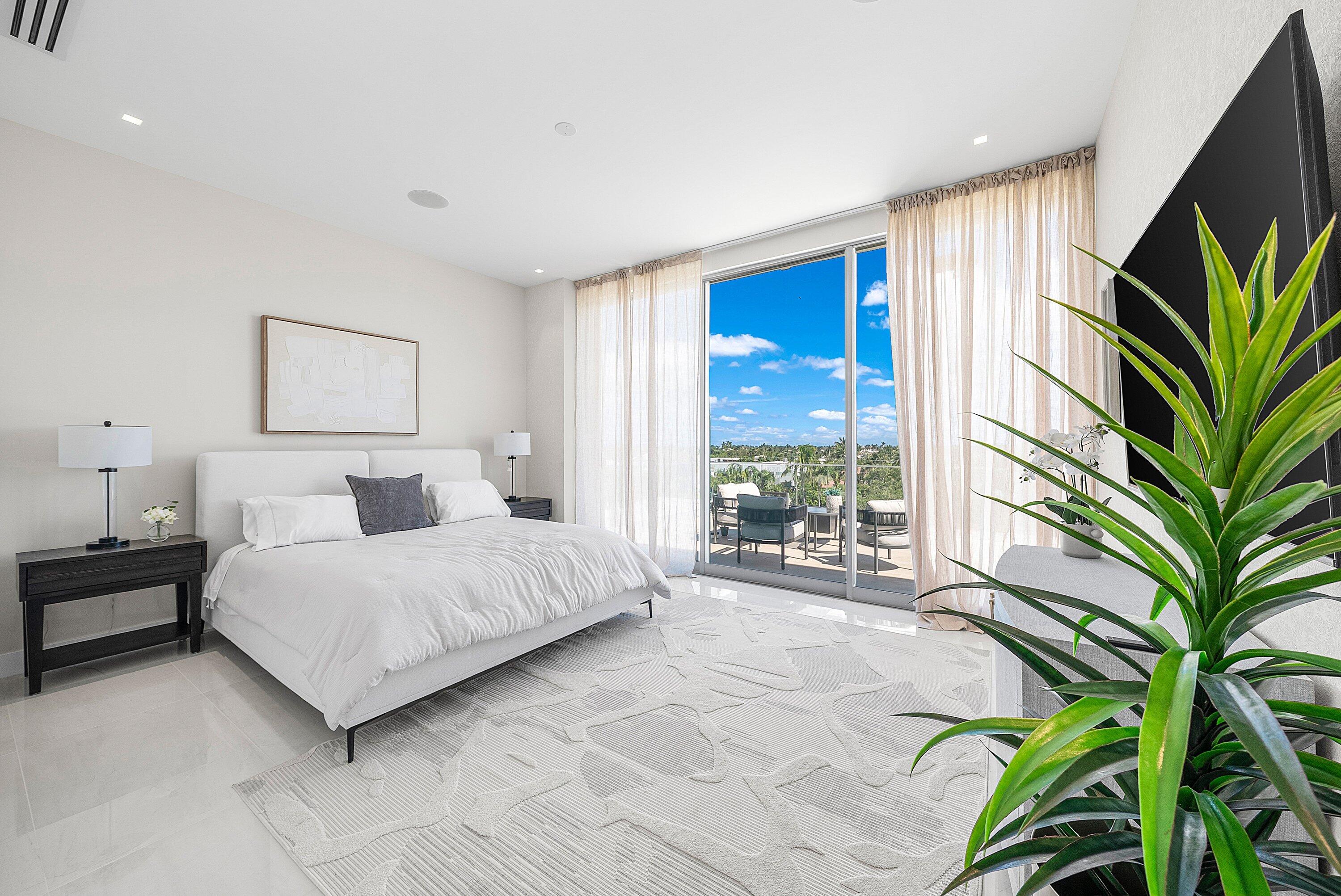 246 Northeast 6th Avenue, Unit PH Delray Beach, FL 33483 - Photo 19 of 36 a spacious bedroom with a large bed and a potted plant