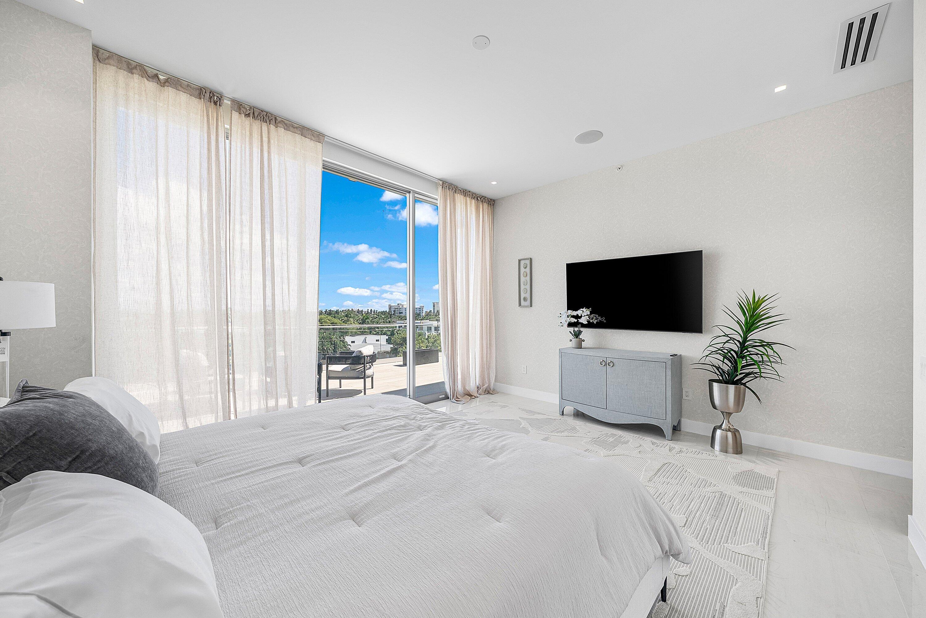246 Northeast 6th Avenue, Unit PH Delray Beach, FL 33483 - Photo 20 of 36 a living room with furniture and a flat screen tv