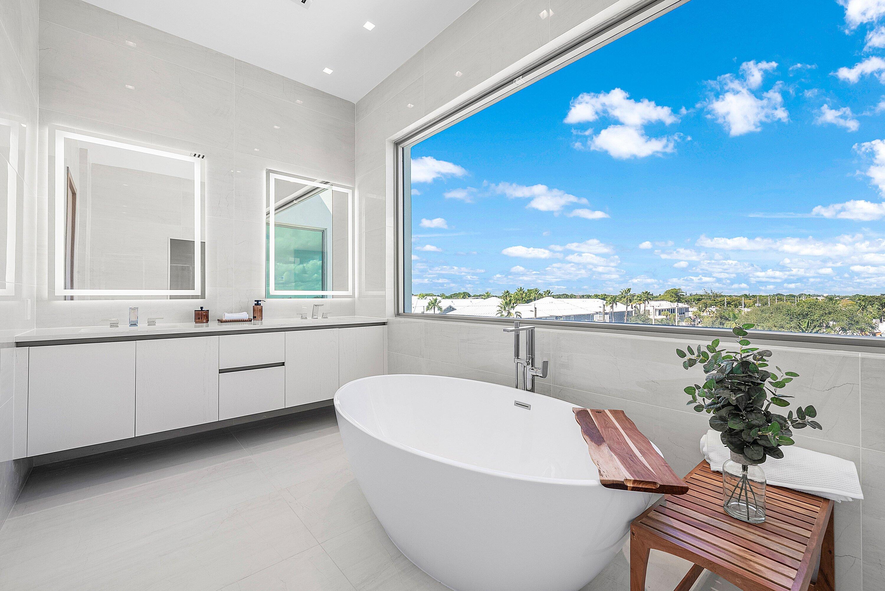 246 Northeast 6th Avenue, Unit PH Delray Beach, FL 33483 - Photo 21 of 36 a bathroom with a tub a sink and mirror