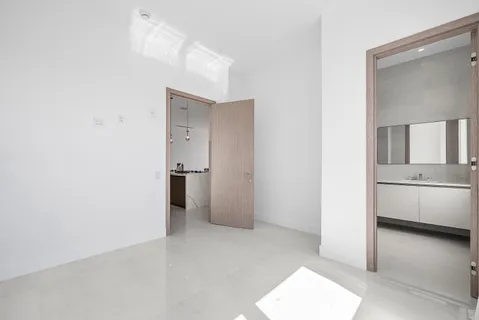 a view of hallway with a sink and a refrigerator