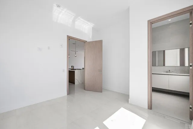 a view of hallway with a sink and a refrigerator