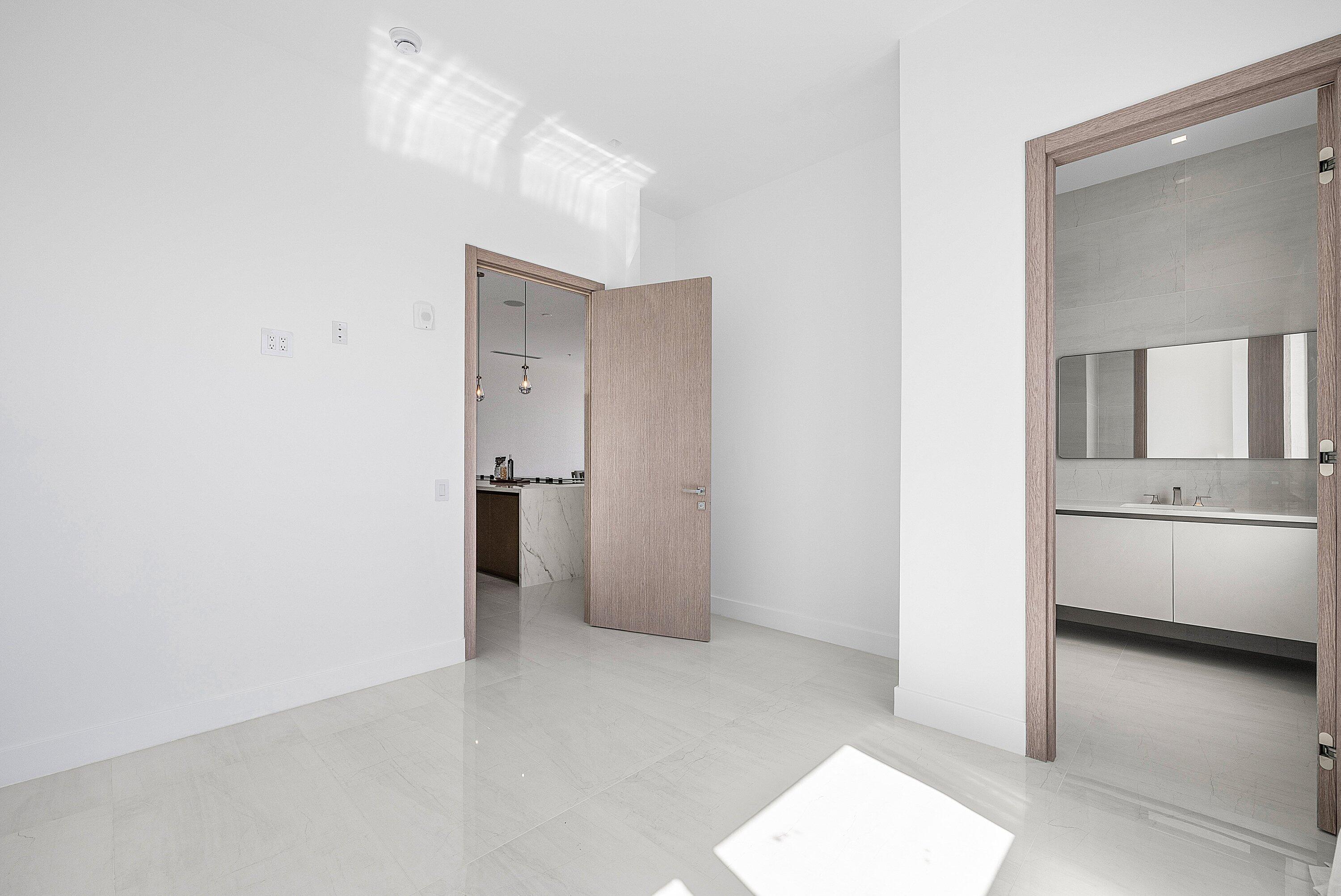 246 Northeast 6th Avenue, Unit PH Delray Beach, FL 33483 - Photo 27 of 36 a view of hallway with a sink and a refrigerator