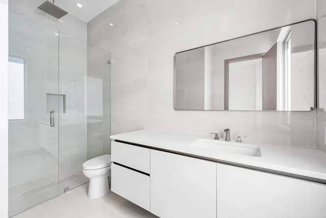 a bathroom with a toilet sink and shower