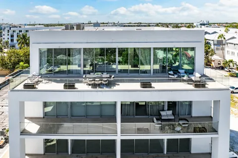 a view of a swimming pool with outdoor seating and yard in the back
